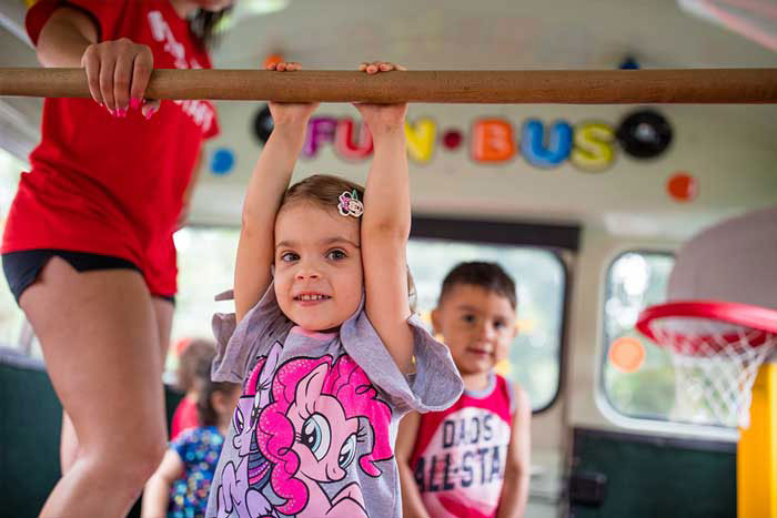 Children playing & learning at a FUN BUS preschool franchise, where there are no hidden fees.