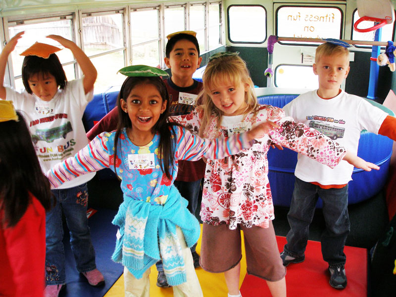 kids dancing in mobile birthday party bus