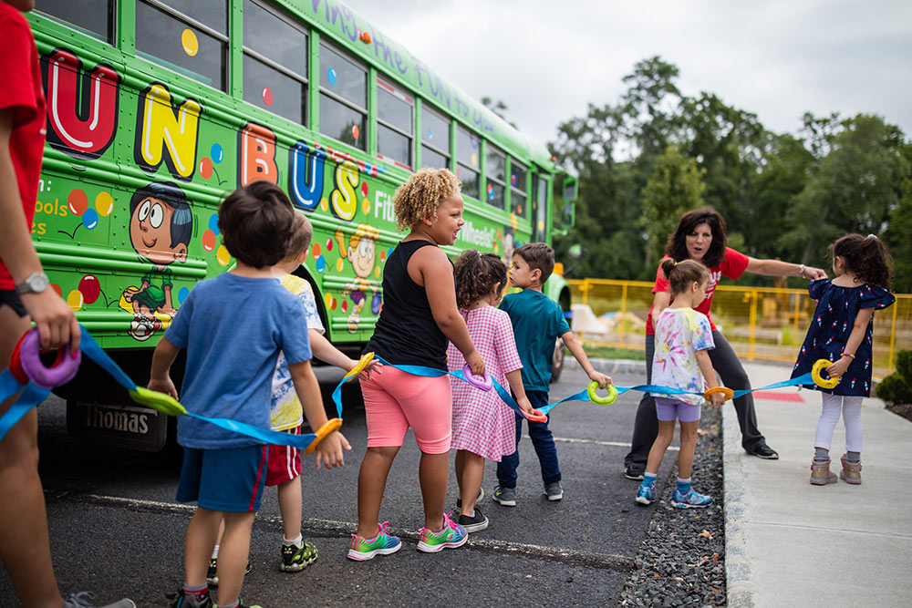 children on mobile birthday party bus Wall