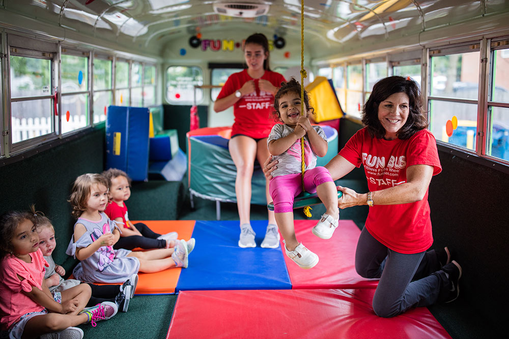 Kids playing & learning at a preschool franchise by FUN BUS.