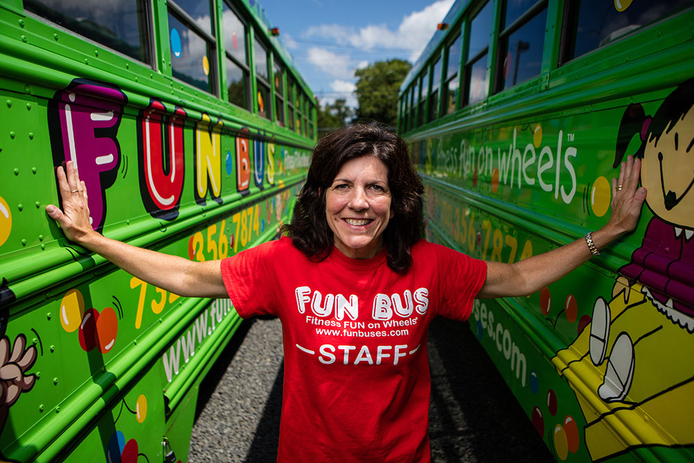 Smiling woman who opened a kids franchise with FUN BUS.