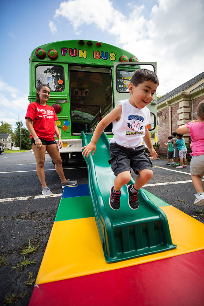 A child playing outside a Fun Bus - learn more about children's franchise opportunities.