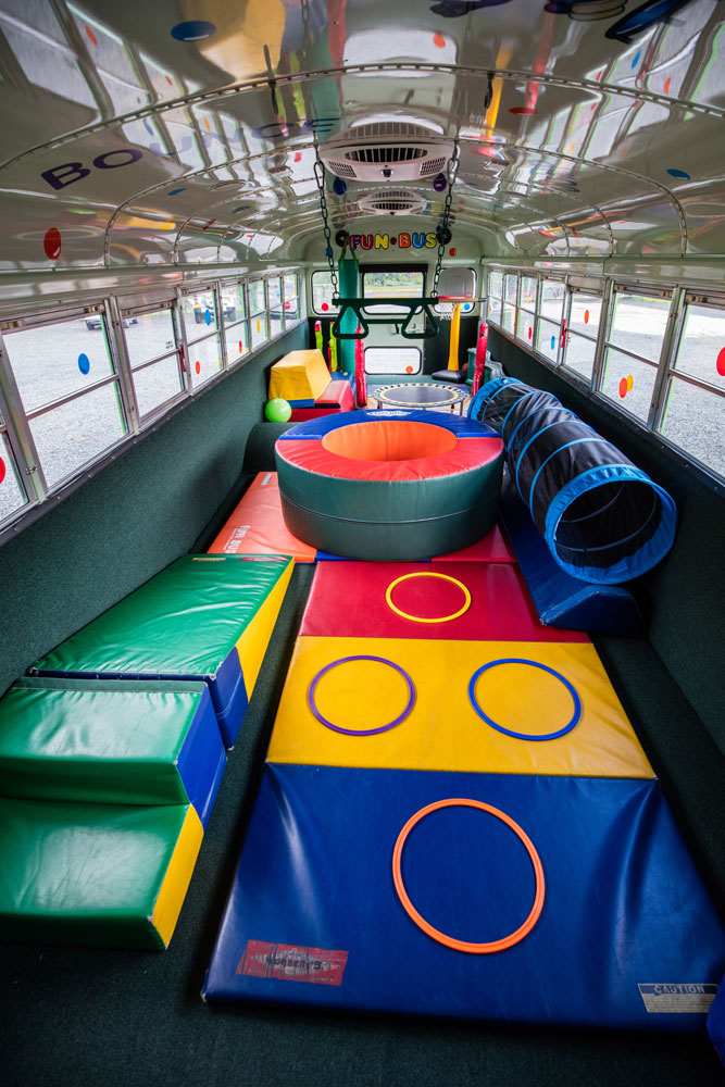 The inside of the bus is colorful, fun, and fully padded for safety.