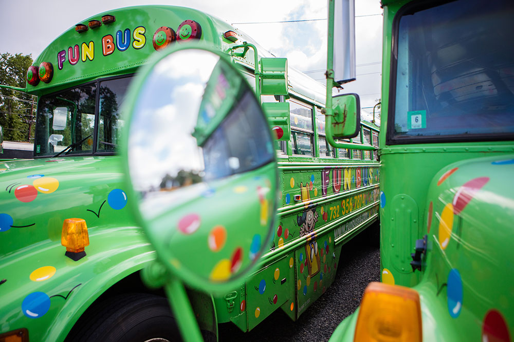 Green buses from FUN BUS Mobile Gym Franchis