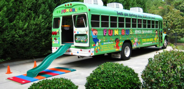 parked kids party bus with slide on the back